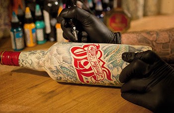 This tattooed bottle of J&B Scotch is one of out top 10 whisky bottle designs